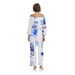 White off-the-shoulder jumpsuit with blue floral tile print, stylish and elegant attire