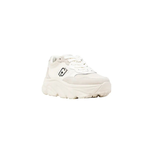 White faux leather slip-on women’s sneakers with a black logo on the side