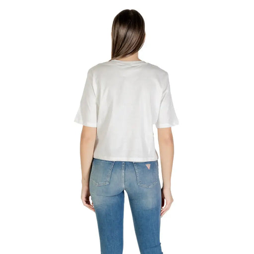 White short-sleeved cotton T-shirt with a round neck paired with blue denim jeans
