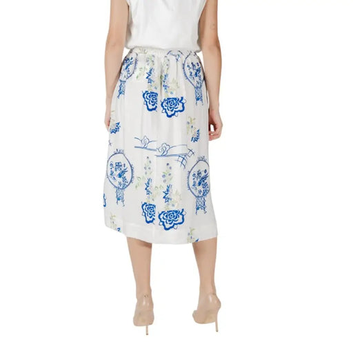 White midi skirt featuring a blue floral pattern suitable for fashion enthusiasts