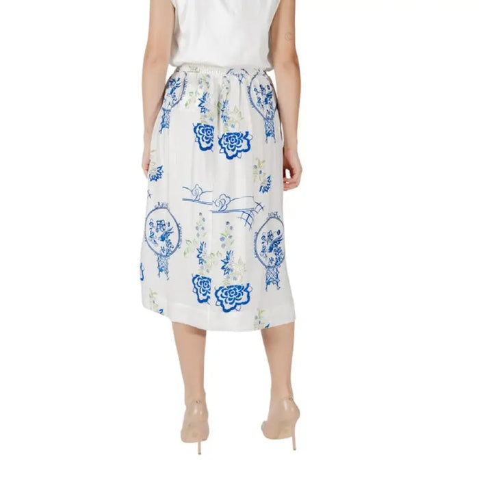 White midi skirt featuring a blue floral pattern suitable for fashion enthusiasts