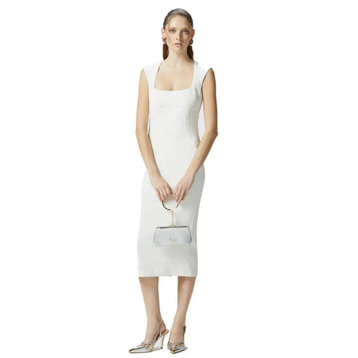 White sleeveless midi sheath dress displayed in a stylish fashion retail setting