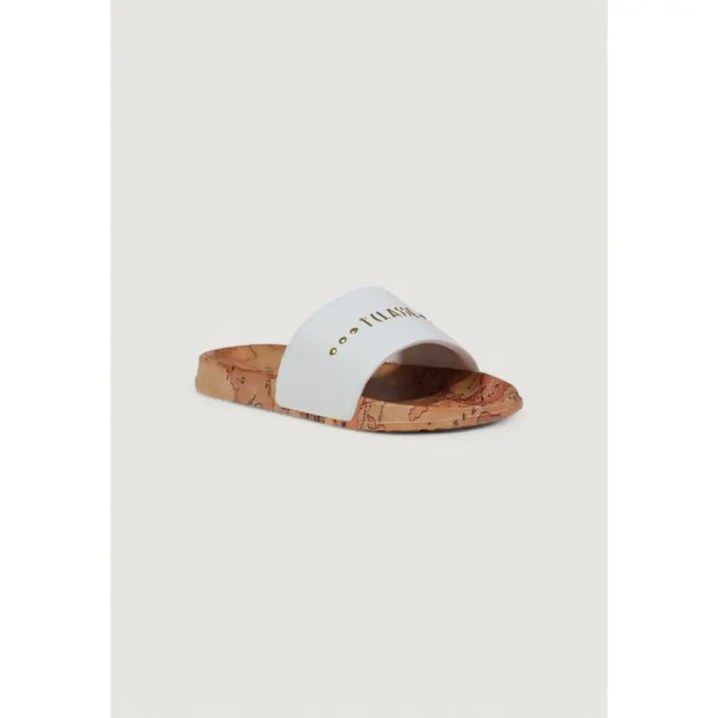 White slide sandal with a cork sole featuring a world map design and gold lettering on the strap