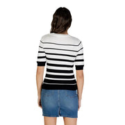 Femme en cardigan à manches courtes boutonné à rayures blanches, rayures horizontales noires et blanches