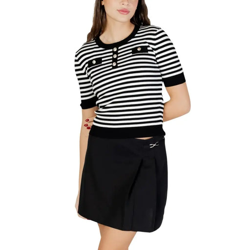 Black and white striped short-sleeved knit top with button details featuring a round neck design