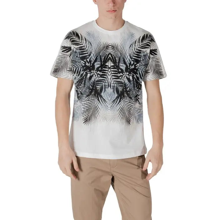 Man wearing a white T-shirt with black and gray palm leaf pattern and khaki pants