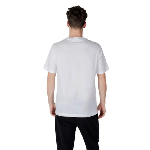 White Calvin Klein T shirt worn by a person, showcasing classic casual style