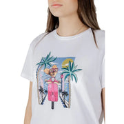 White cotton t-shirt featuring a vibrant cartoon graphic of a dog riding a pink scooter through a tropical cityscape