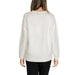 White textured knit sweater paired with black pants for a stylish, comfortable look