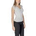 White V-neck top with lace cap sleeves paired with black pants by Morgan De Toi