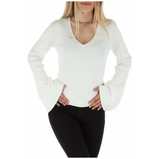 White V-neck sweater with flared bell sleeves for women displayed in the product listing