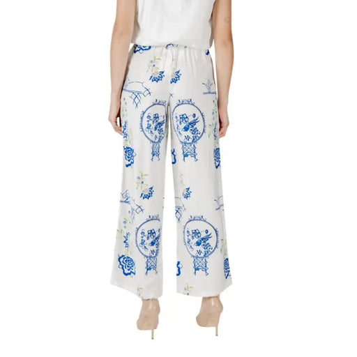White wide-leg pants featuring a blue floral pattern for stylish women’s wear