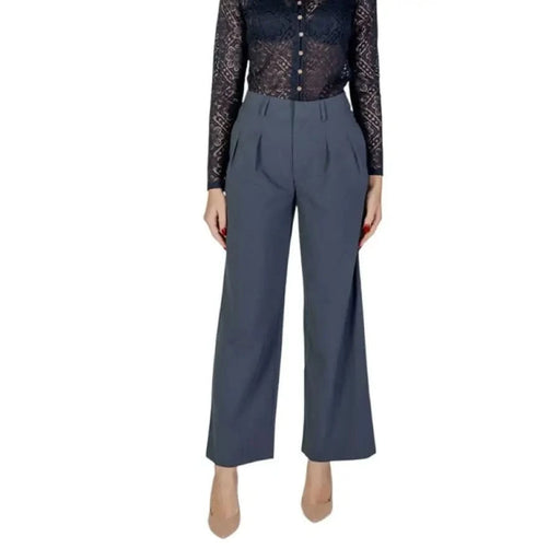 Wide-leg gray dress pants with pockets paired with a black lace top, Calvin Klein Jeans