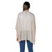 Woman wearing a beige poncho from the Women’s Beige Cardigans and Poncho Collection