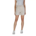 Woman in beige cotton shorts and white sneakers from B.young with pockets