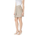 Woman wearing a beige mini skirt and heels, showcasing Women’s Beige and Khaki Mini Skirt