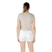 Woman wearing beige T shirt and white denim shorts in a casual summer outfit