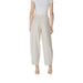 Woman showcasing stylish beige pleated trousers in wide-leg design