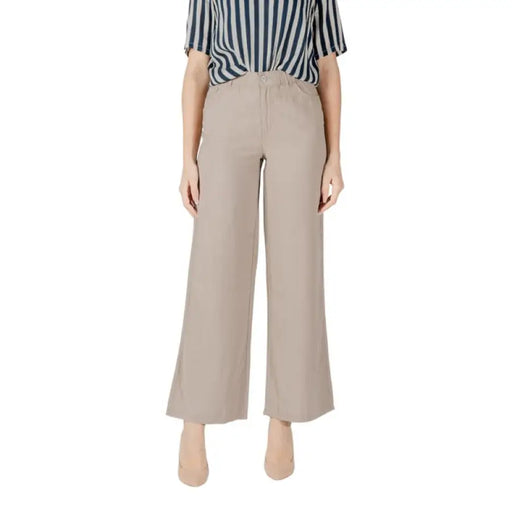 Woman model showcasing stylish Beige Wide Leg Pants for Women in a chic setting