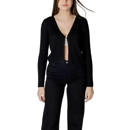 Woman wearing Morgan De Toi Black V-Neck Cardigan and black pants
