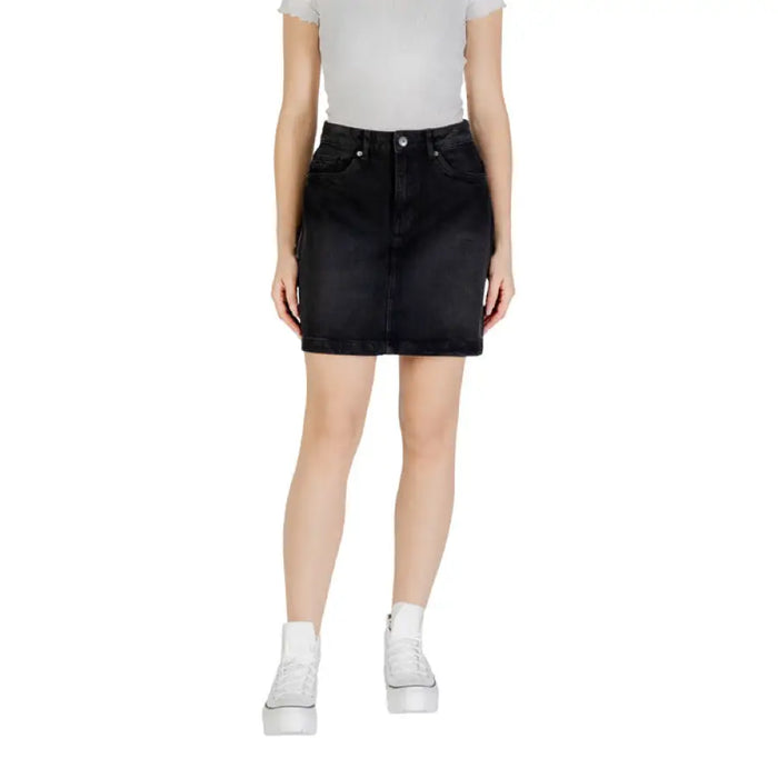 Woman wearing a black denim skirt showcasing a Light Blue Denim Mini Skirt product