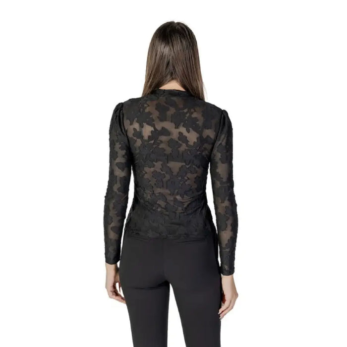 Woman wearing Black Floral Lace Long Sleeve Top with floral-patterned black top and pants