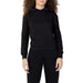Woman in black Fila hoodie showcasing urban city style fashion