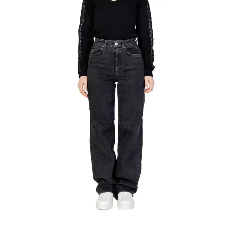 Woman wearing Women’s Black Wide Leg Jeans and black top showcasing stylish attire