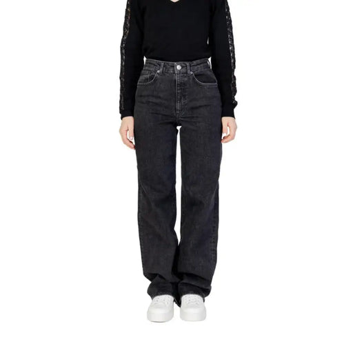 Woman wearing Women’s Black Wide Leg Jeans and black top showcasing stylish attire