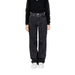 Woman wearing Women’s Black Wide Leg Jeans and black top showcasing stylish attire