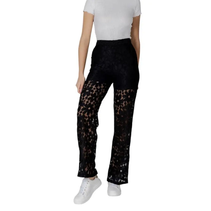 Woman modeling Elegant Black Lace Pants with fashionable black lace detailing
