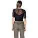 Woman wearing a black lace top and khaki pants showcasing women’s fashion style