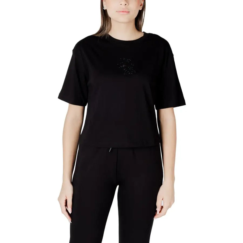 Woman in black short-sleeve T-shirt and track pants showcasing Womens White T Shirt product