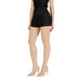 Elegant woman in black highwaisted skort and nude heels showcasing stylish fashion