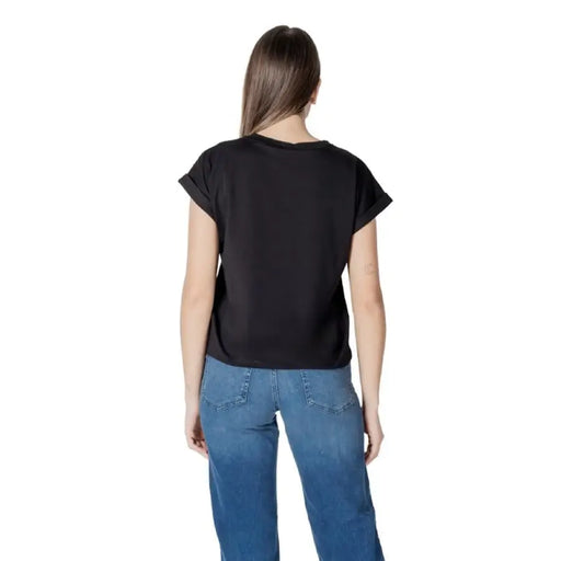 Woman wearing Liu Jo Black T Shirt and blue jeans showcasing casual fashion style