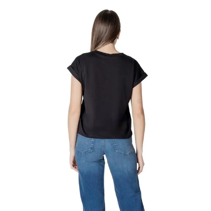 Woman wearing Liu Jo Black T Shirt and blue jeans showcasing casual fashion style