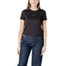 Woman wearing a black T shirt and dark blue jeans showcasing Women’s Beige T Shirt and White Denim Shorts