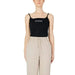 Woman in Guess Active tank top and beige pants