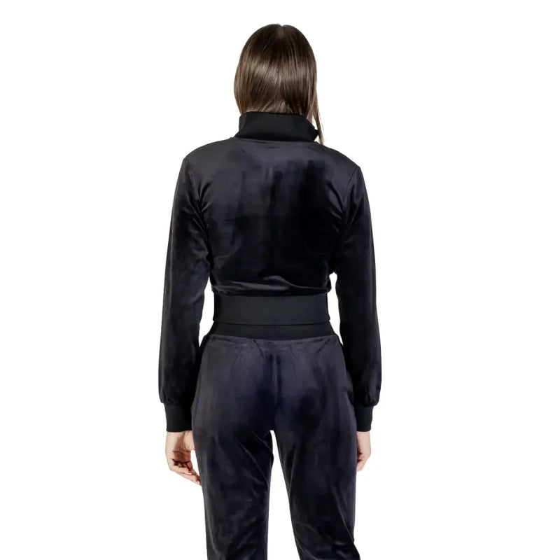 Woman wearing Guess Active Black Velvet Tracksuit with Rhinestone Zip Front Sweatshirt