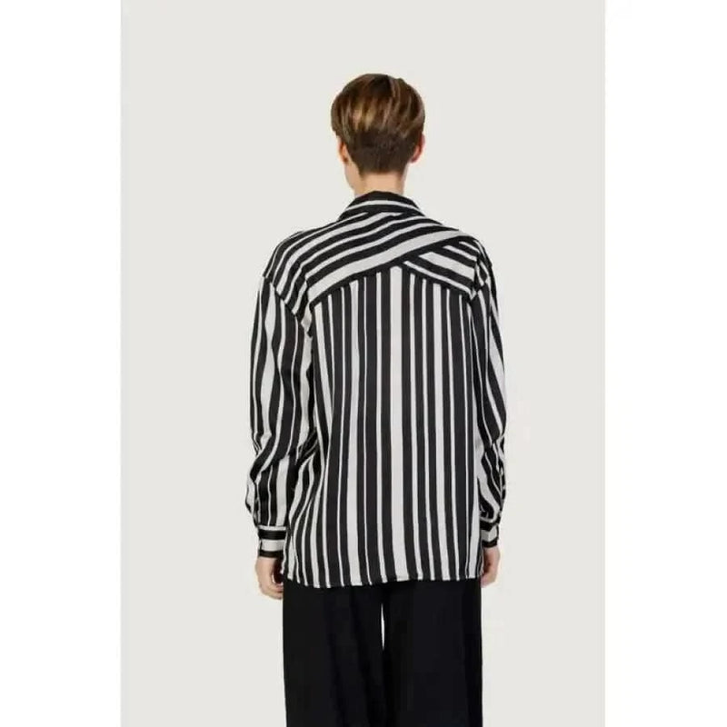 Woman in Only black and white striped women shirt showcasing urban city fashion