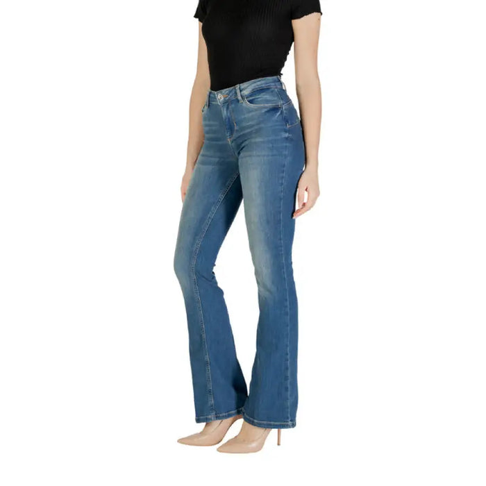 Woman wearing blue denim flare jeans for women, showcasing stylish blue flared pants