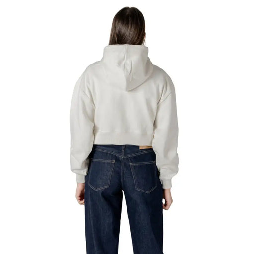 Woman wearing a cropped hoodie and jeans showcasing the Women Hooded Sweatshirt and Jeans product