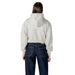 Woman wearing a cropped hoodie and jeans showcasing the Women Hooded Sweatshirt and Jeans product