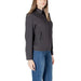 Woman wearing dark gray collared jacket and blue jeans showcasing women’s fashion