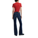 Woman wearing dark wash flared jeans showcasing the Women’s Flare Jeans in Blue and Dark Wash product
