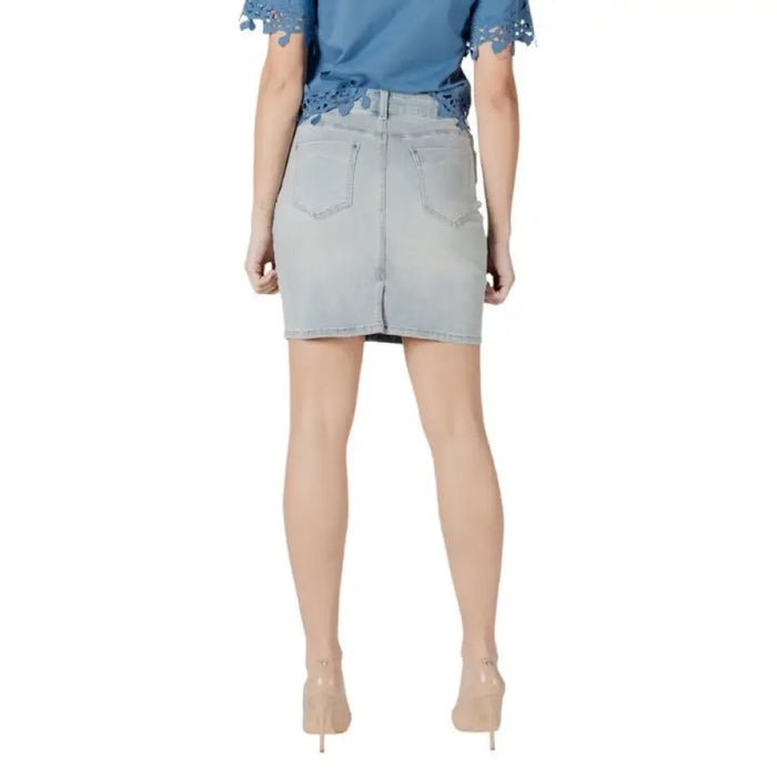 Woman wearing a denim skirt and heels in the Blue Top and Denim Skirt Outfit With Heels displayed