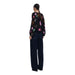 Woman wearing floral print balloon sleeve button down blouse and wide-leg jeans