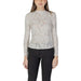 Woman wearing a black floral lace long sleeve top and black pants