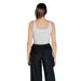 Woman wearing a gray cropped tank top and black pants for Womens Cropped Tank Top and Black Pants