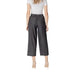 Woman styled in gray culottes and heels, showcasing Gray Cropped Pleated Pants